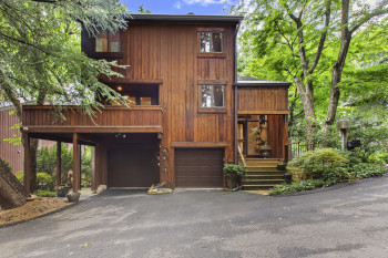 View of front facade featuring a garage and driveway