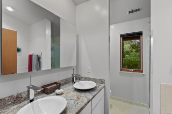 Bathroom with double vanity and a shower with door