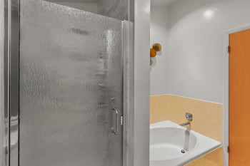 Bathroom with a shower stall and a garden tub