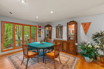 Dining area with light wood finished floors and recessed lighting