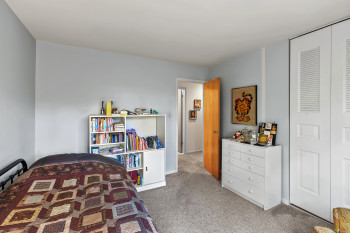 Bedroom with carpet and a closet