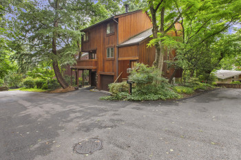 View of building exterior with driveway and a garage