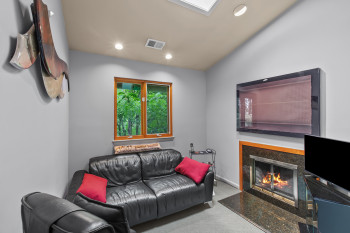 Carpeted living area featuring a fireplace and recessed lighting