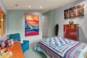 Carpeted bedroom with recessed lighting and a closet
