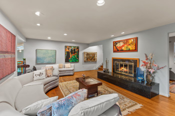 Living area with a fireplace, recessed lighting, and wood finished floors