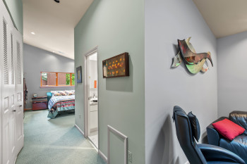 Corridor with light carpet and recessed lighting