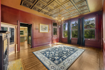 Dining area featuring a chandelier, an ornate ceiling, wood finished floors, and ornamental molding