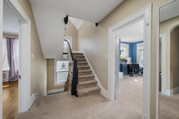 Stairs with arched walkways and carpet