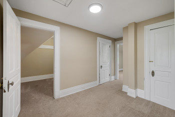 Corridor featuring carpet and baseboards