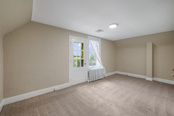 Bonus room featuring radiator heating unit, vaulted ceiling, and carpet
