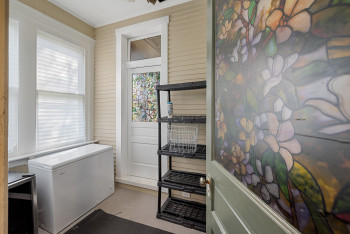 Laundry room with beverage cooler and ornamental molding