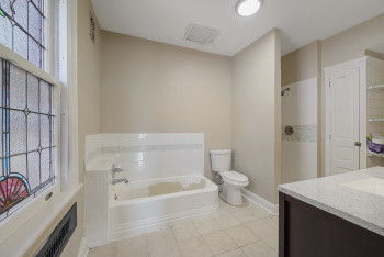 Full bath featuring a bath, tile patterned floors, vanity, and healthy amount of natural light
