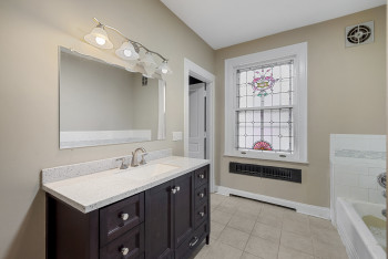Bathroom featuring vanity, tile patterned floors, and a tub