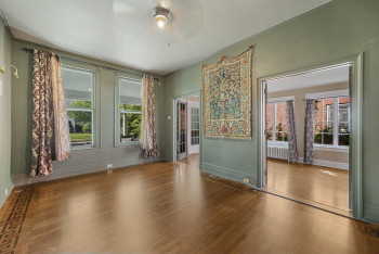 Spare room with wood finished floors, a ceiling fan, and plenty of natural light