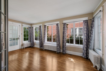 Unfurnished sunroom featuring radiator and plenty of natural light