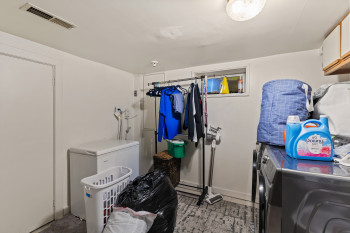 Washroom featuring cabinet space and washer and dryer