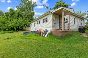 Back of house with a lawn