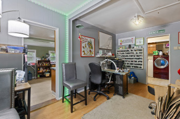 Office area featuring wood finished floors, washer / dryer, and attic access