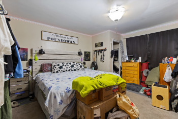 Carpeted bedroom with ornamental molding