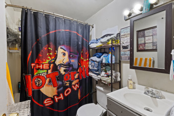 Full bathroom with vanity and a shower with curtain