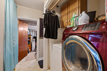 Laundry room with washer and clothes dryer and cabinet space