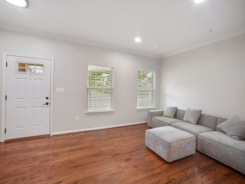 Living room featuring wood finished floors, ornamental molding, plenty of natural light, and recessed lighting