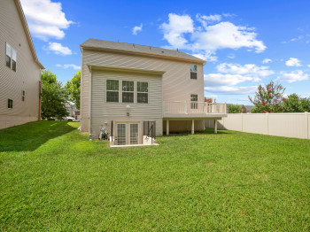 Rear view of house featuring a wooden deck