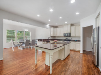 Kitchen with stainless steel appliances, recessed lighting, light wood finished floors, a peninsula, and white cabinets