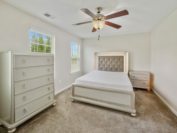 Bedroom with carpet flooring and ceiling fan