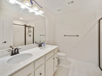 Bathroom with a stall shower and double vanity