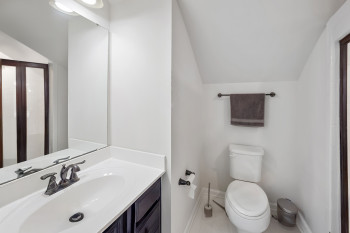 Bathroom with vaulted ceiling, vanity, and an enclosed shower