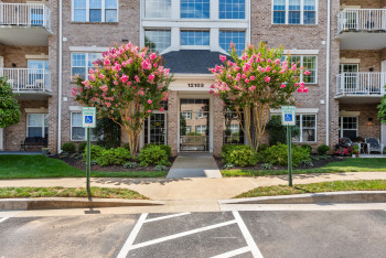 View of building exterior with uncovered parking