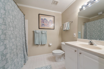 Full bath with crown molding, light tile patterned flooring, vanity, and a shower with curtain