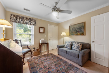 Sitting room featuring crown molding, light carpet, and a ceiling fan