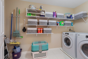 Laundry room featuring light tile patterned floors and washer and clothes dryer