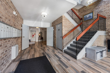 Common area with brick wall and stairs