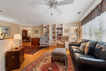 Living area with light wood-type flooring, ornamental molding, ceiling fan, and recessed lighting