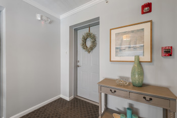 Foyer entrance with ornamental molding and baseboards