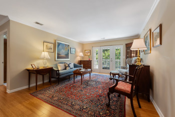 Living room with ornamental molding and light wood finished floors