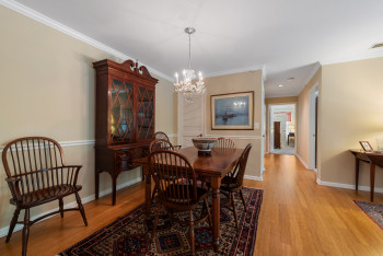 Dining space with crown molding, a chandelier, and light wood-style floors