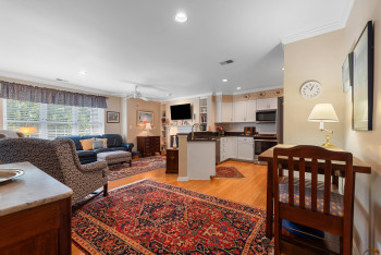 Living room with ornamental molding, light wood finished floors, recessed lighting, and ceiling fan