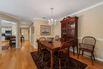 Dining space featuring light wood-style floors, ornamental molding, and a chandelier