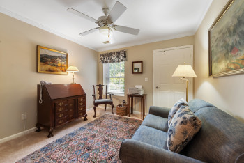 Living area with crown molding, carpet, and a ceiling fan