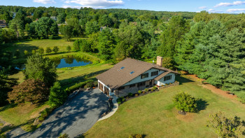 Aerial view of house and pond