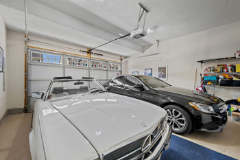 2 Car Garage featuring garage door openers and extra cabinets/storage