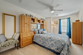 Substantial Upper level Bedroom 1 with light colored carpet and ceiling fan