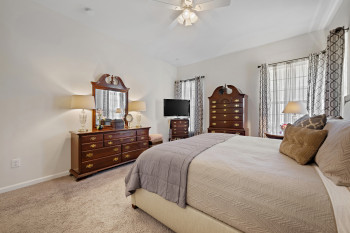 Alternate view of Primary Bedroom featuring multiple tall windows bringing much light into the room