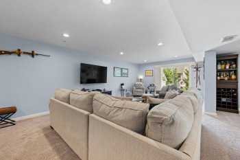 Lower level was custom designed and finished by Owners contractors not the builder. Includes living room, full bath, bar area, walk out to rear yard area, extra closets and separate storage/workroom area.