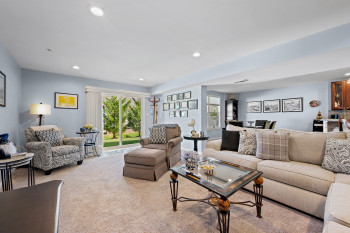 Living area with recessed lighting and carpet floors