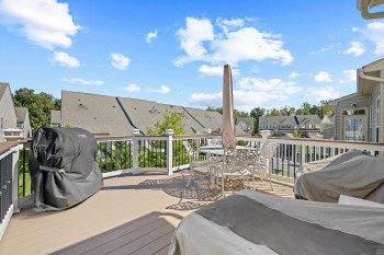 Deck with a residential view, area for grilling, and outdoor dining space. Finished with trex like flooring for low maintenance